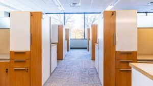 Modern office cubicle with fabric panels, wedge worksurface, credenza storage, privacy partitions, and whiteboard doors.HDR 2