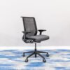 Steelcase Think V2 ergonomic office chair with grey mesh back and charcoal grey fabric seat, featuring adjustable 4D armrests and lumbar support.