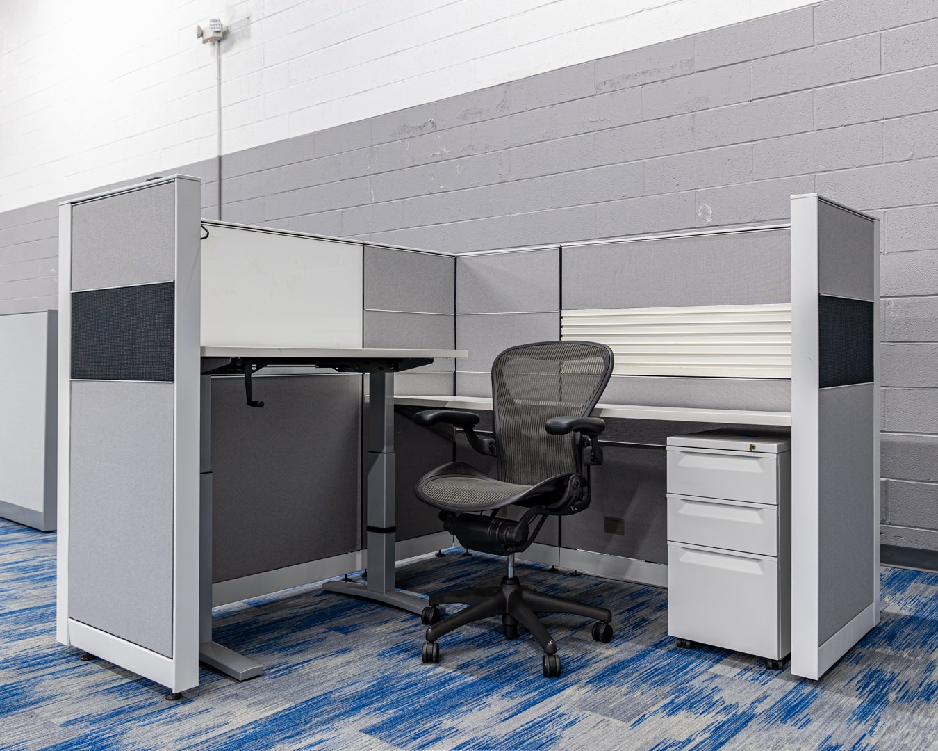 Full view of the Herman Miller Canvas workstation, 6'x6' size, artic white frame, black and gray tiles.