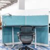 Full view of the Haworth 3-Pack Cubicle with frosted tempered glass panels and cornered sit-stand desks.