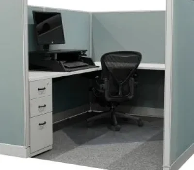 Preowned workstation featuring a cubicle with a desk, multiple storage drawers, ergonomic task chair, and computer with accessories.